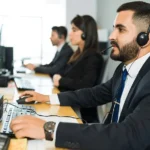 attractive latin executive offering customer service with headset offering tech support busy call center
